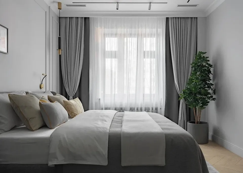 Neutral-toned bedroom with no clutter and soft bedding