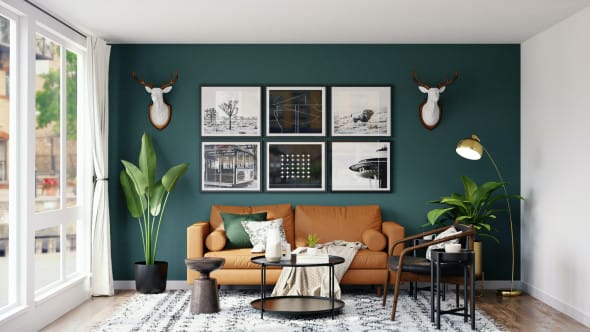 Contemporary living room with green accent wall, camel leather sofa, and wall art.