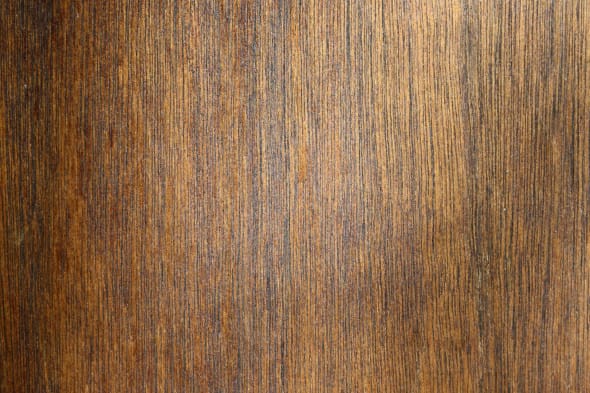 Close-up of walnut wood texture with earthy brown tones