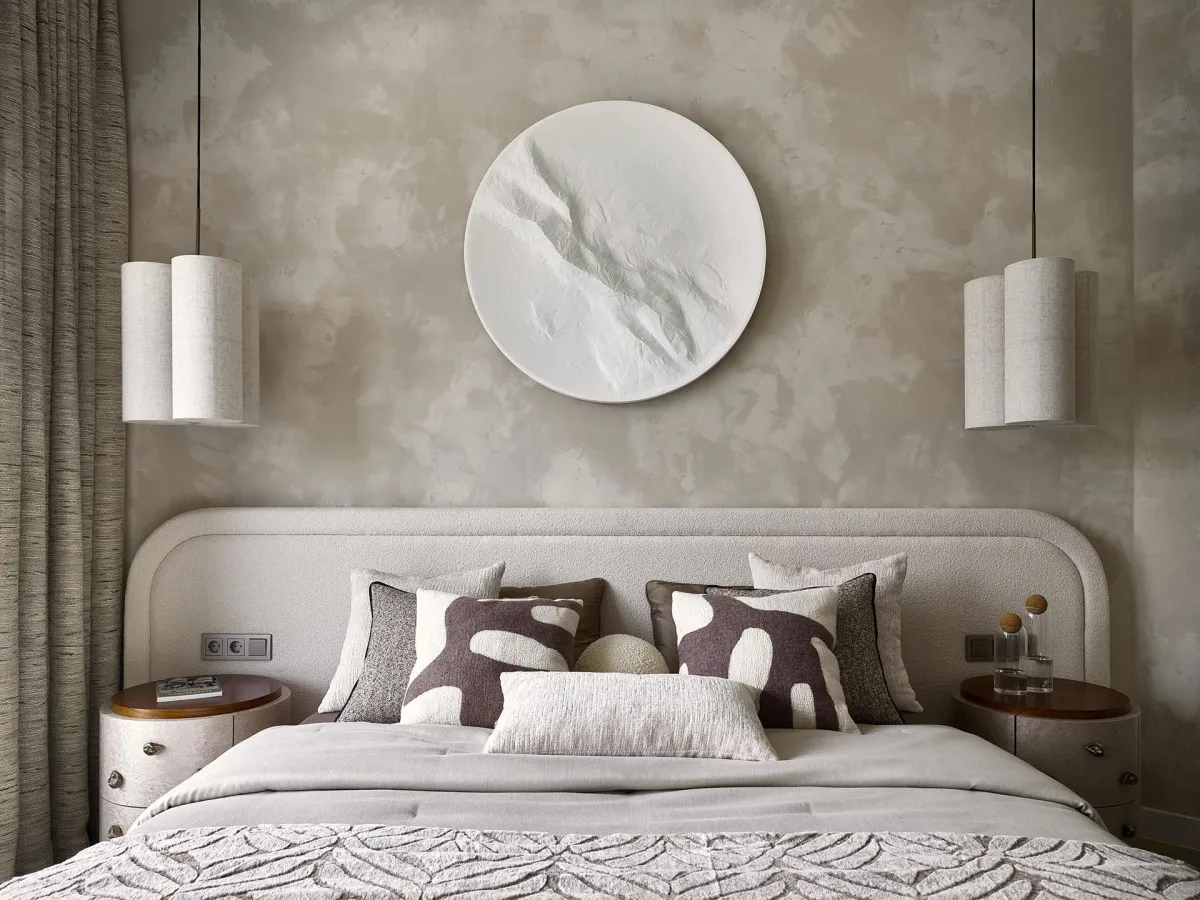 Soft lighting and layered bedside lamps in a minimalist bedroom