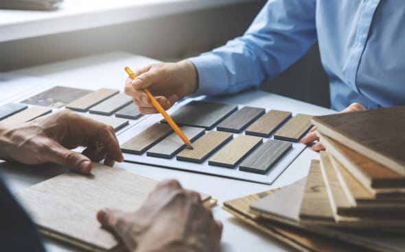 Interior designers comparing wood color samples for furniture selection
